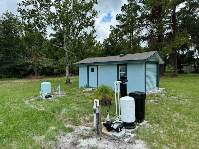 view of outdoor structure featuring a lawn