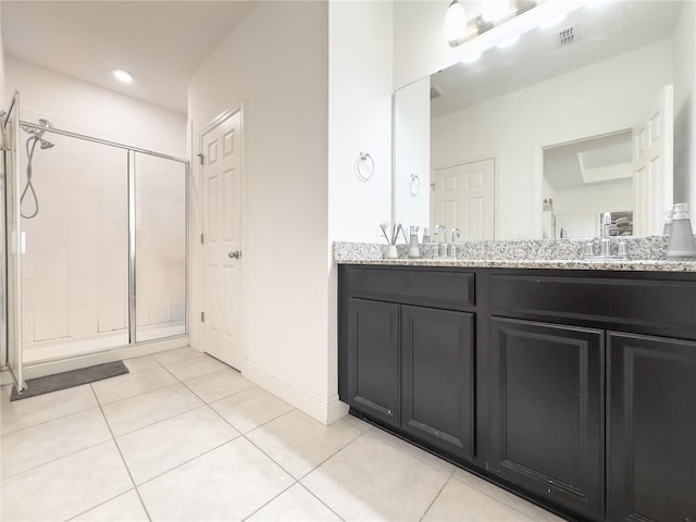 bathroom featuring walk in shower, tile patterned floors, and vanity