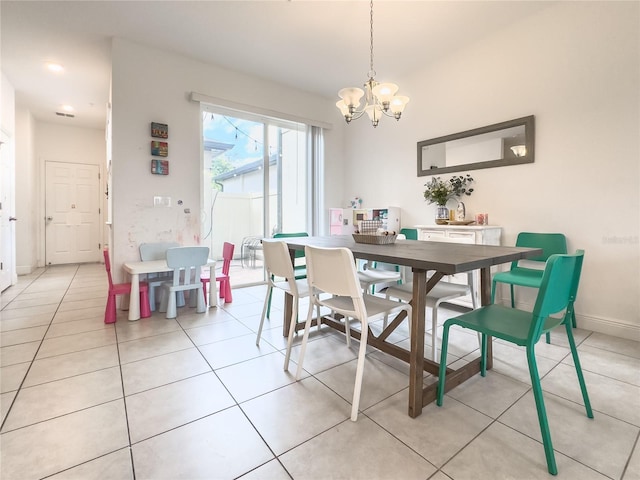 tiled dining area featuring a chandelier