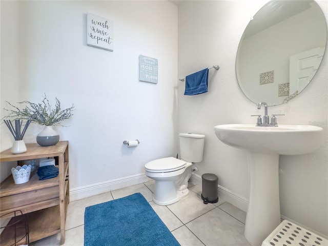 bathroom featuring toilet, tile patterned flooring, and sink