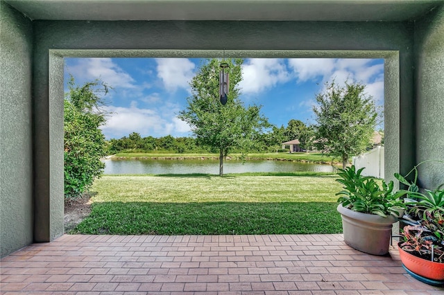 view of yard featuring a water view and a patio