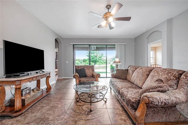 tiled living room featuring ceiling fan