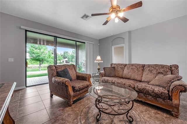 tiled living room with ceiling fan