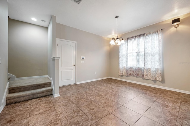 tiled empty room with a notable chandelier