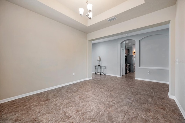 empty room with a notable chandelier