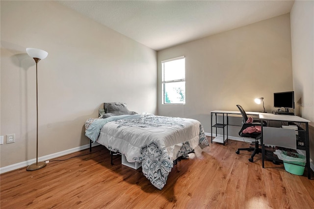 bedroom with light hardwood / wood-style floors