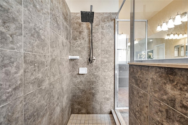 bathroom featuring tile patterned floors and tiled shower