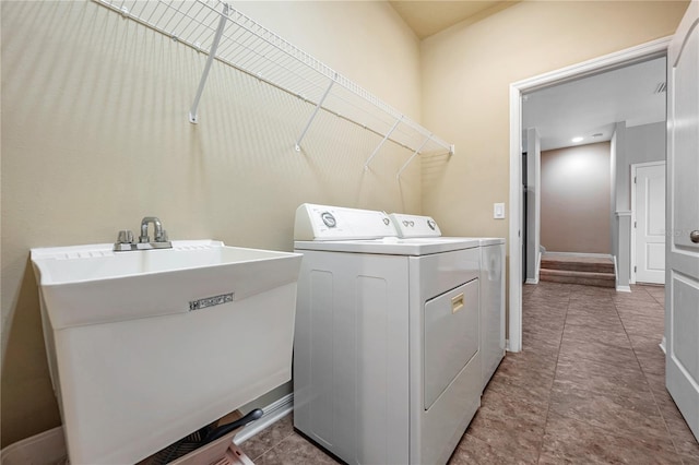 laundry area with independent washer and dryer and sink