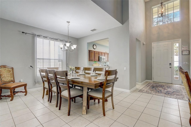 tiled dining area with a chandelier