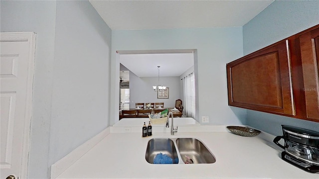 kitchen with sink, hanging light fixtures, and a chandelier