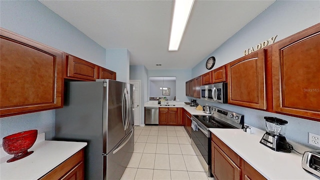 kitchen featuring sink, light tile patterned flooring, and appliances with stainless steel finishes