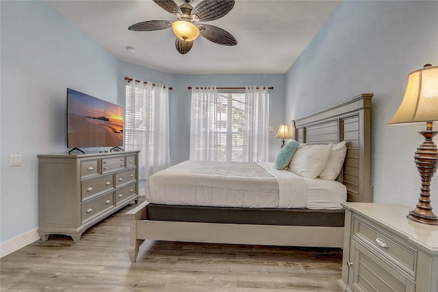 bedroom with light hardwood / wood-style flooring and ceiling fan