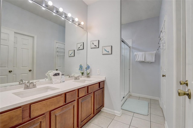 bathroom featuring tile patterned flooring, vanity, and a shower with shower door