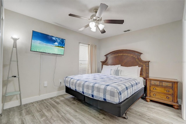 bedroom with light hardwood / wood-style flooring and ceiling fan