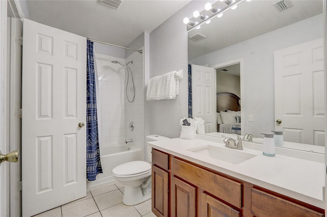 full bathroom with shower / bath combo, vanity, tile patterned flooring, toilet, and a textured ceiling