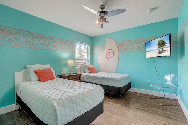 bedroom with ceiling fan and hardwood / wood-style flooring