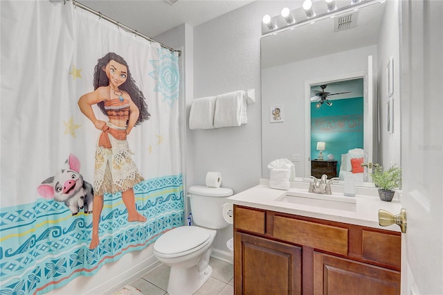 full bathroom featuring vanity, tile patterned floors, ceiling fan, toilet, and shower / bath combo with shower curtain