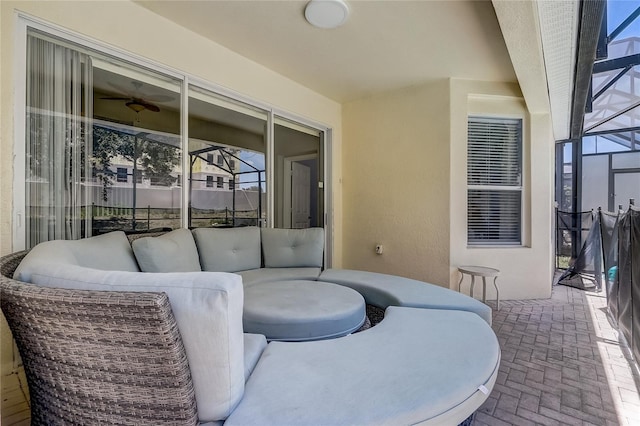 view of patio with glass enclosure and outdoor lounge area