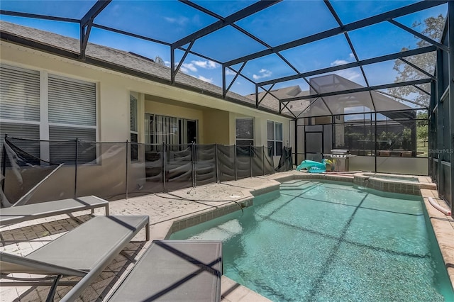 view of swimming pool with glass enclosure, a patio area, and an in ground hot tub