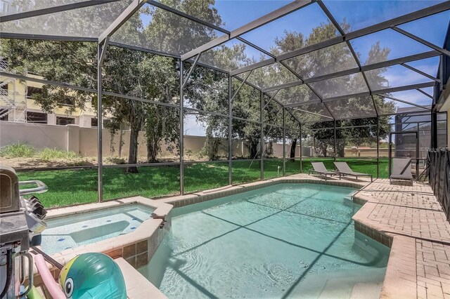 view of swimming pool with a lawn, a patio area, an in ground hot tub, and a lanai