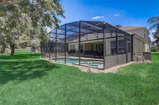 back of house with a lawn, central AC unit, a lanai, and a swimming pool with hot tub