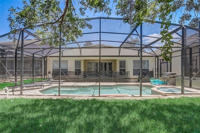 back of house with glass enclosure and a pool with hot tub