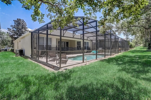 rear view of property with central AC, a yard, a patio, and a lanai