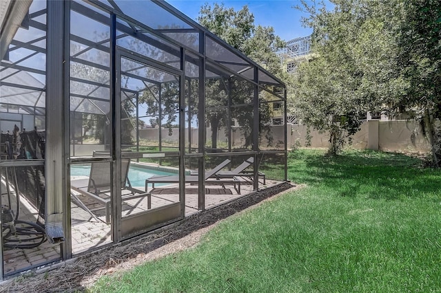 view of yard with a fenced in pool, glass enclosure, and a patio area