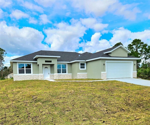 view of front of property with a garage and a front lawn