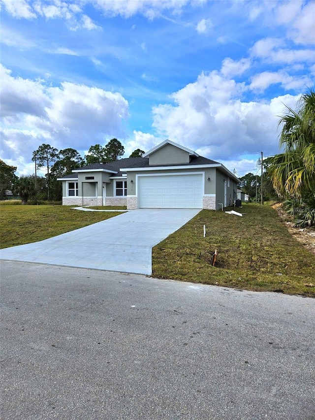 ranch-style house with a garage and a front lawn