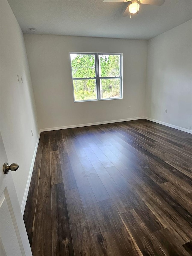 spare room featuring ceiling fan and dark hardwood / wood-style flooring