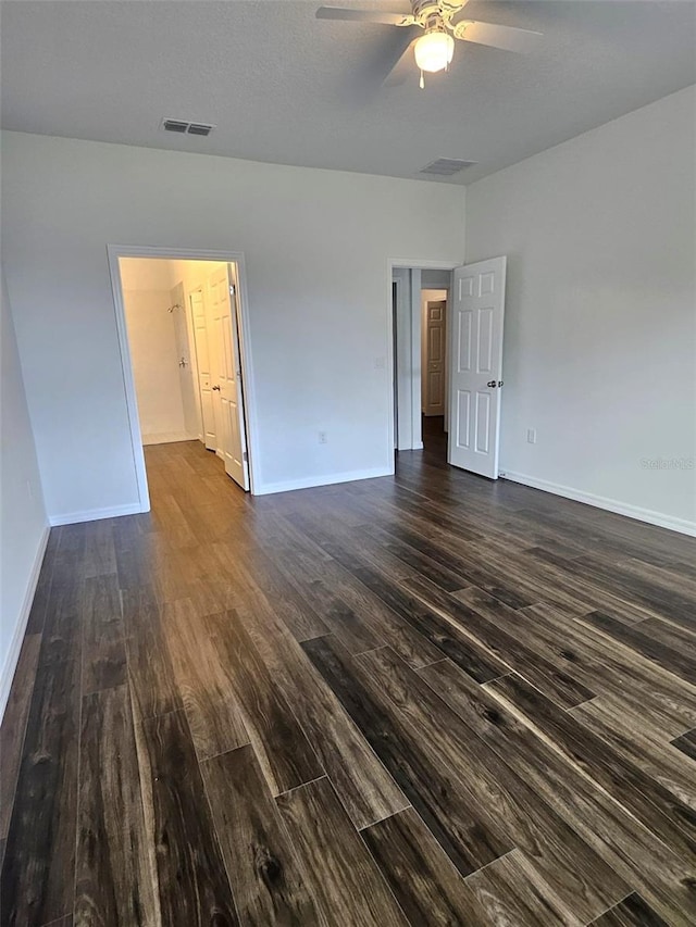 empty room featuring dark hardwood / wood-style floors and ceiling fan