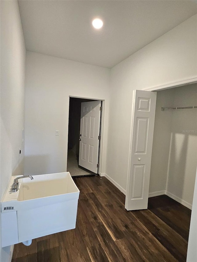 bathroom with wood-type flooring, a bathing tub, and sink