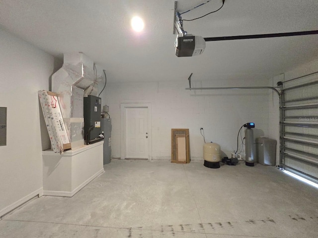 garage with electric water heater, a garage door opener, and heating unit