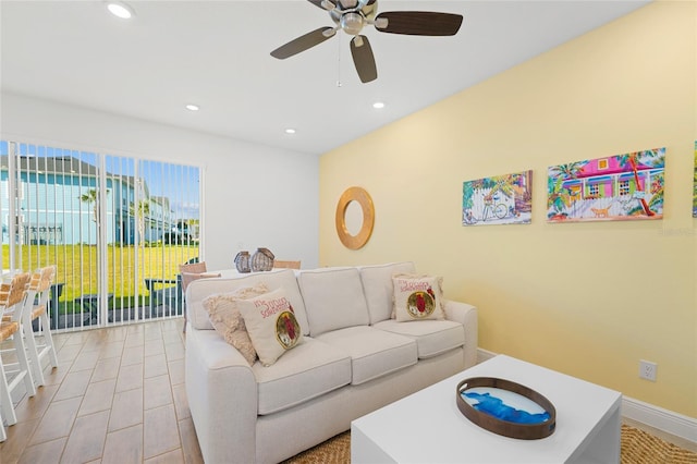 living room with ceiling fan and light wood-type flooring