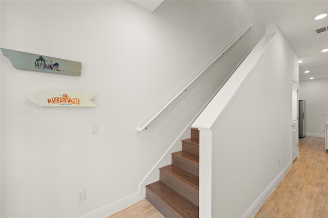 stairs featuring wood-type flooring