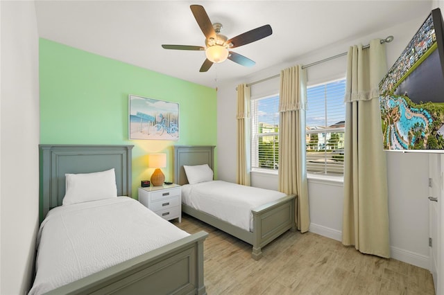 bedroom featuring ceiling fan and light hardwood / wood-style flooring