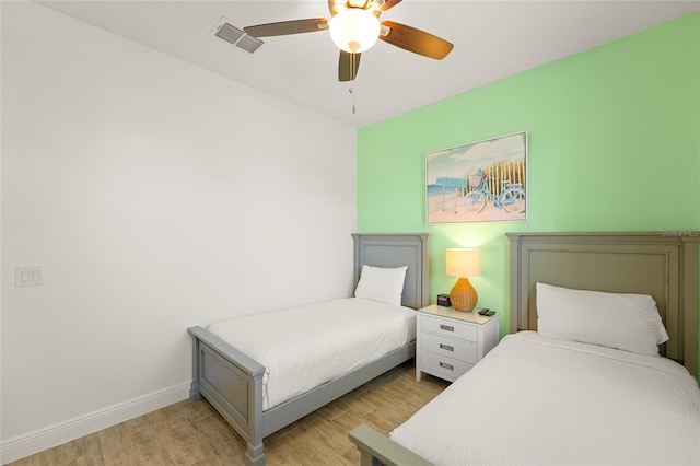 bedroom with light hardwood / wood-style floors and ceiling fan