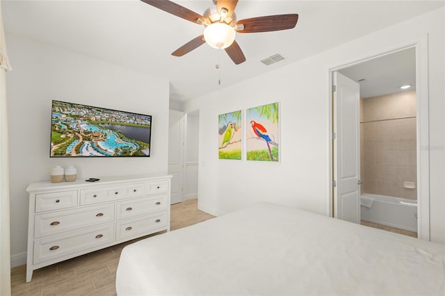 bedroom featuring ceiling fan, light wood-type flooring, and connected bathroom