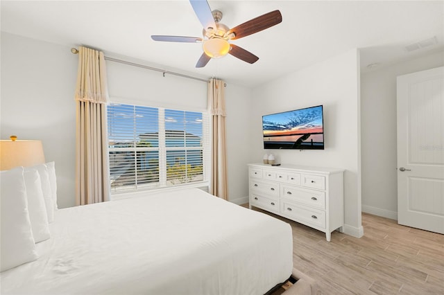 bedroom with ceiling fan and light hardwood / wood-style floors