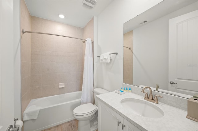 full bathroom with hardwood / wood-style floors, vanity, toilet, and shower / tub combo with curtain