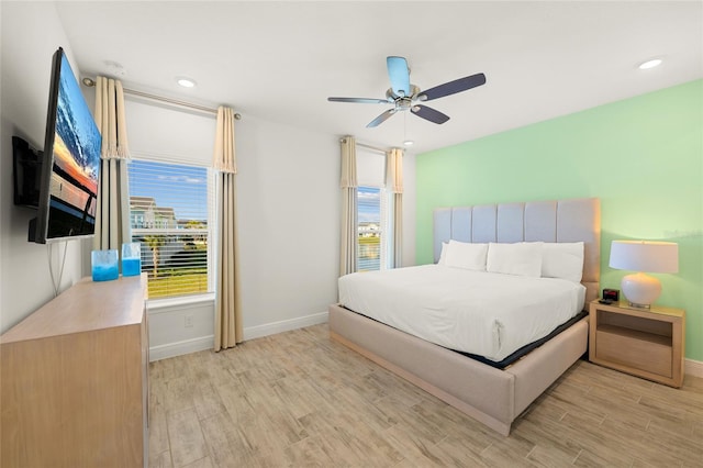 bedroom featuring light hardwood / wood-style flooring and ceiling fan