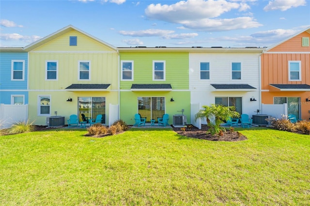 back of property featuring central AC unit, a yard, and a patio