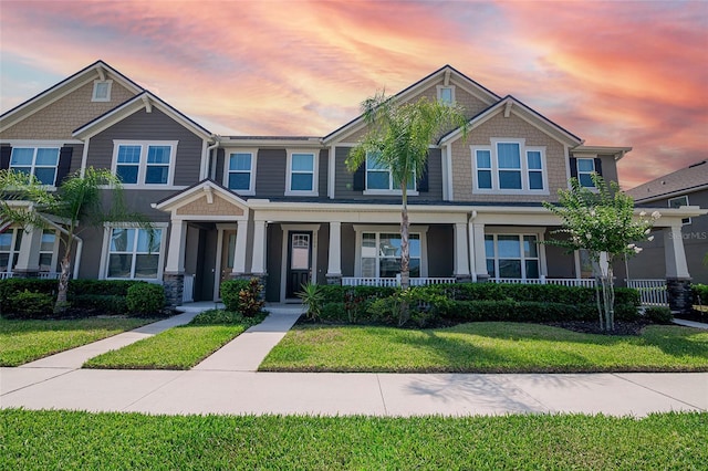 2135 Valencia Blossom St, Clermont, FL 34711 - view of front facade featuring a porch and a lawn
