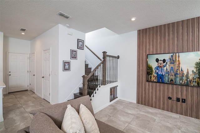 interior space with tile patterned flooring and a textured ceiling