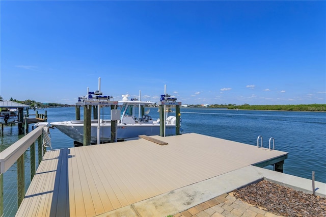 dock with boat lift and a water view