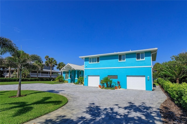 view of front of property with a front yard and a garage