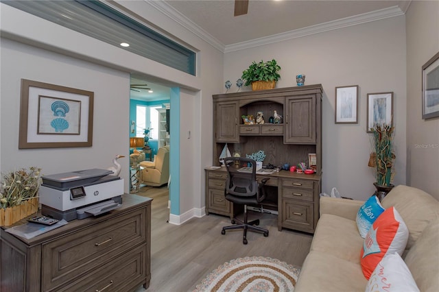 office space featuring ceiling fan, light wood-type flooring, and crown molding