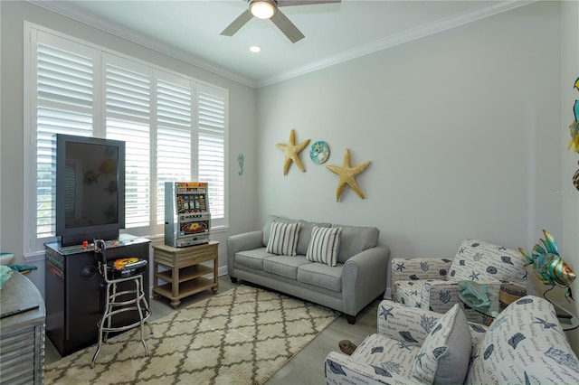 living area featuring ornamental molding, a ceiling fan, wood finished floors, baseboards, and recessed lighting