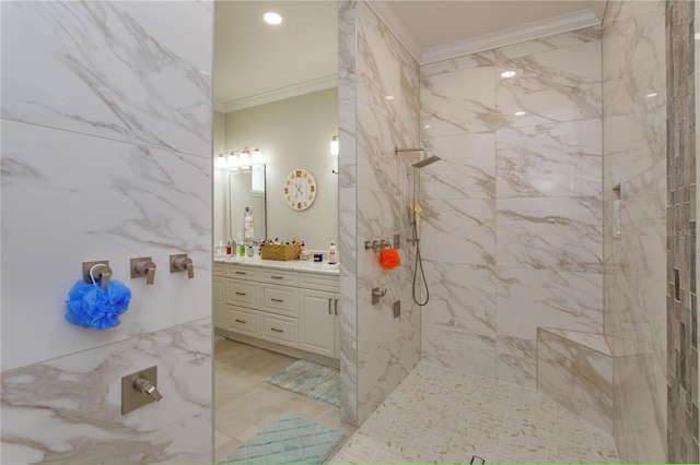 bathroom with vanity, ornamental molding, and tiled shower